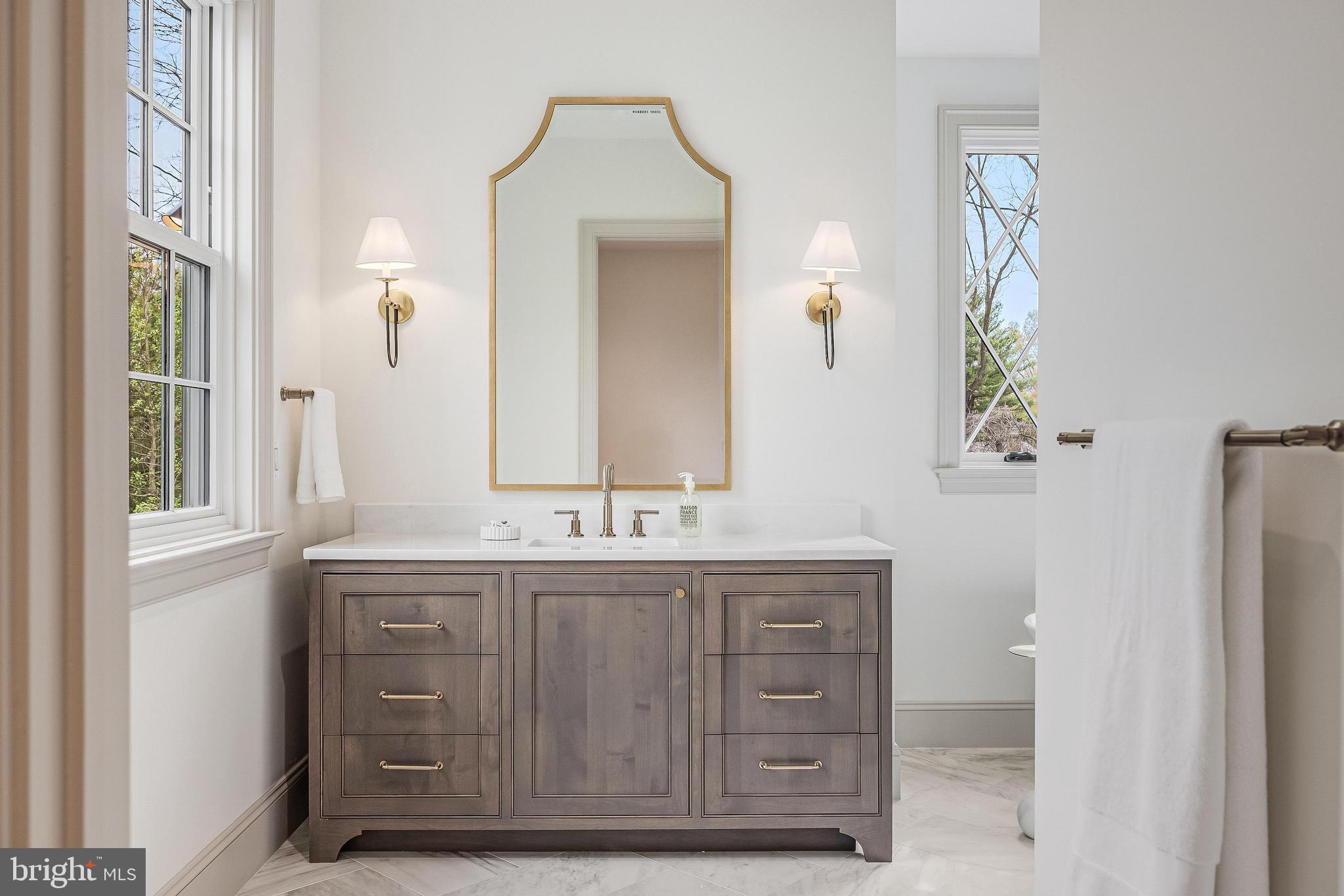 6913 Benjamin Street McLean, VA 22101 - Photo 37 of 51 a bathroom with a granite countertop sink a mirror and a