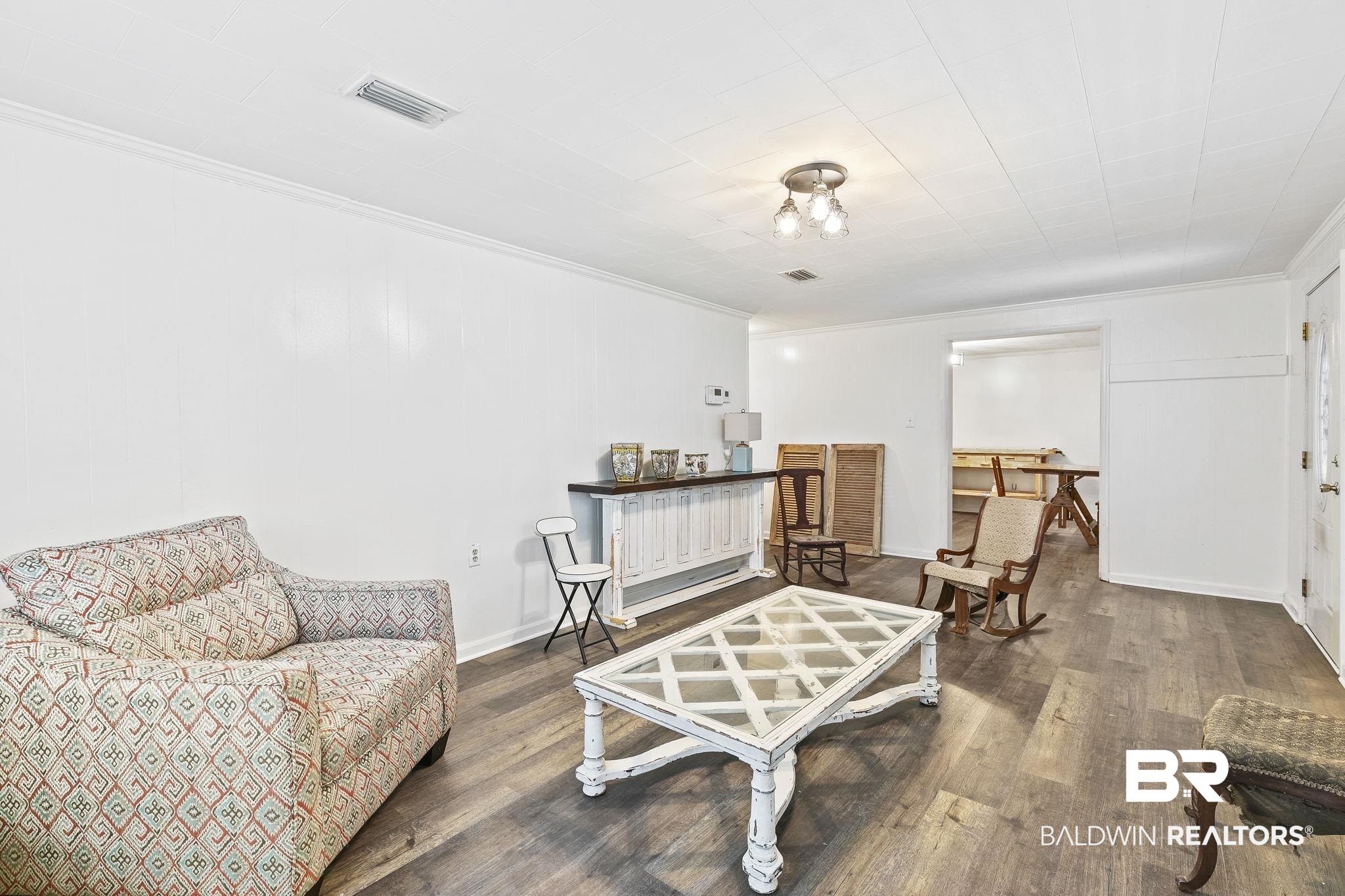 316 West Orchid Avenue Foley, AL 36535 - Photo 11 of 38 Living area featuring crown molding and dark wood finished floors
