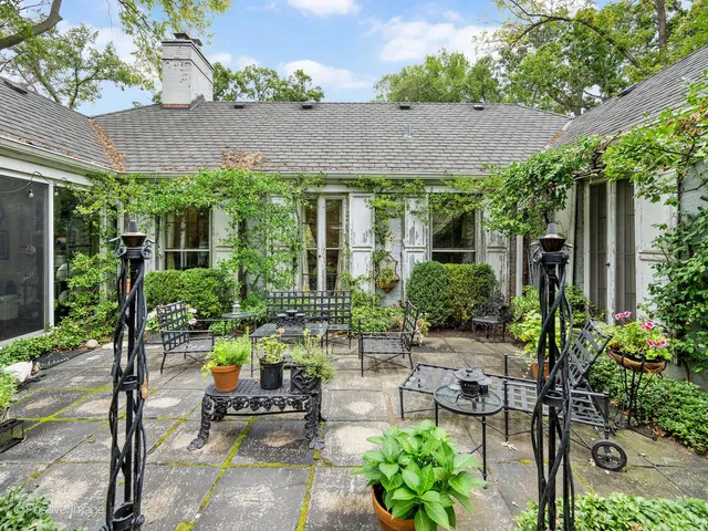 a view of backyard of house with seating space