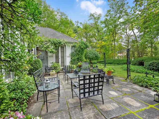 a view of backyard with outdoor seating a patio and plants