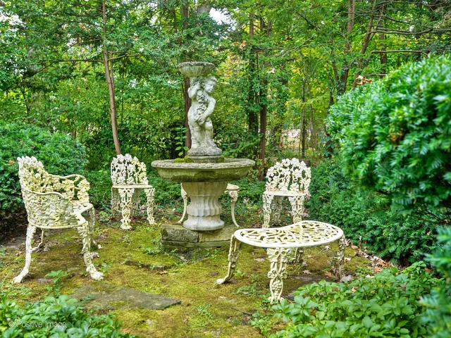 a view of a table and chairs in the garden