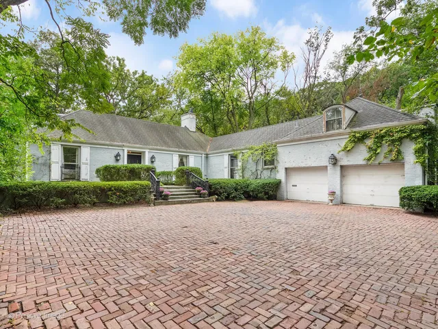 a front view of a house with a yard and a garage