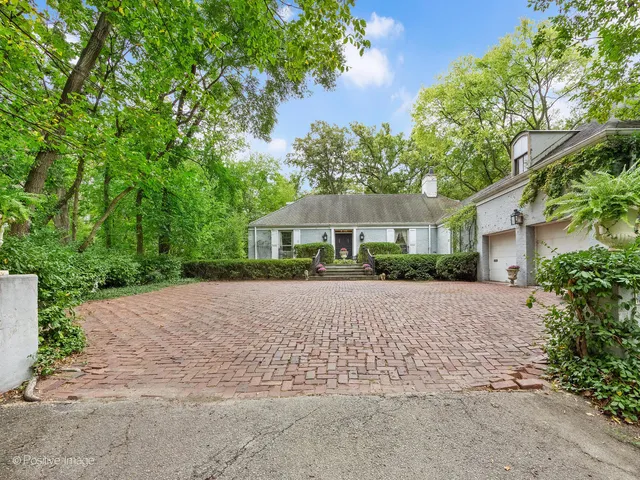 a front view of a house with a yard and a garage