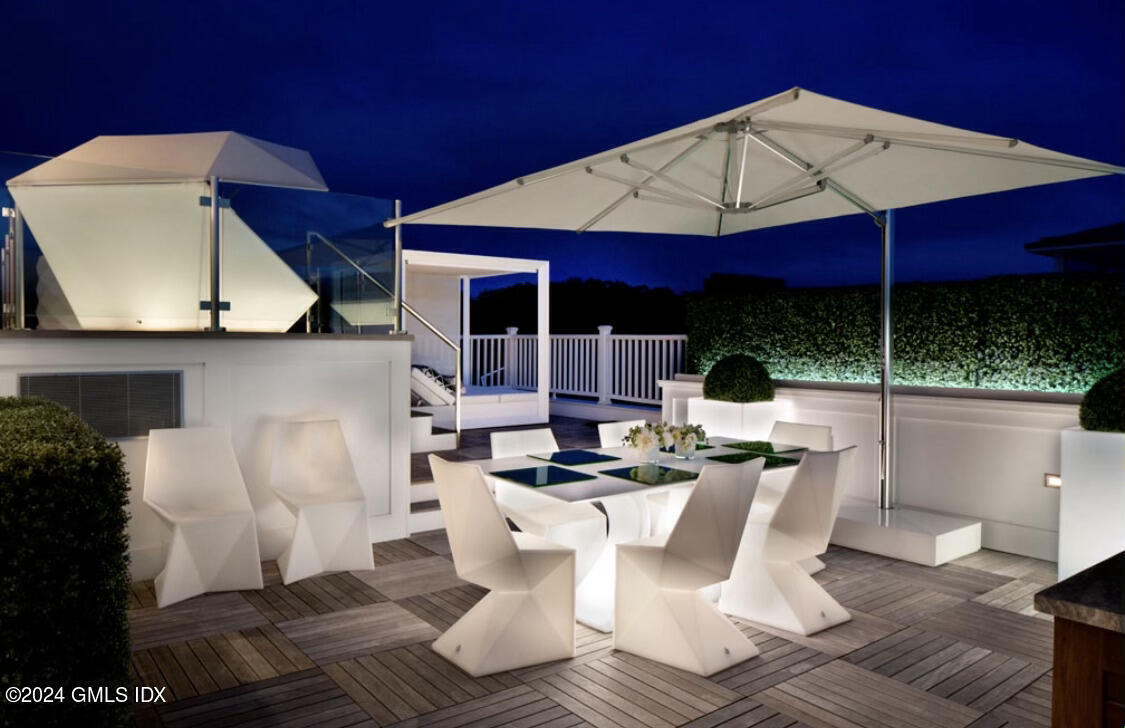 2 Oneida Drive, Unit C2 Greenwich, CT 06830 - Photo 25 of 26 a view of a patio with table and chairs under an umbrella