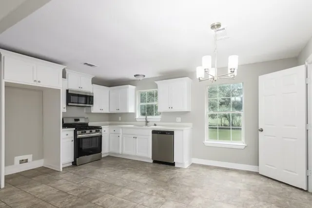 a open kitchen with stainless steel appliances granite countertop a stove and a refrigerator