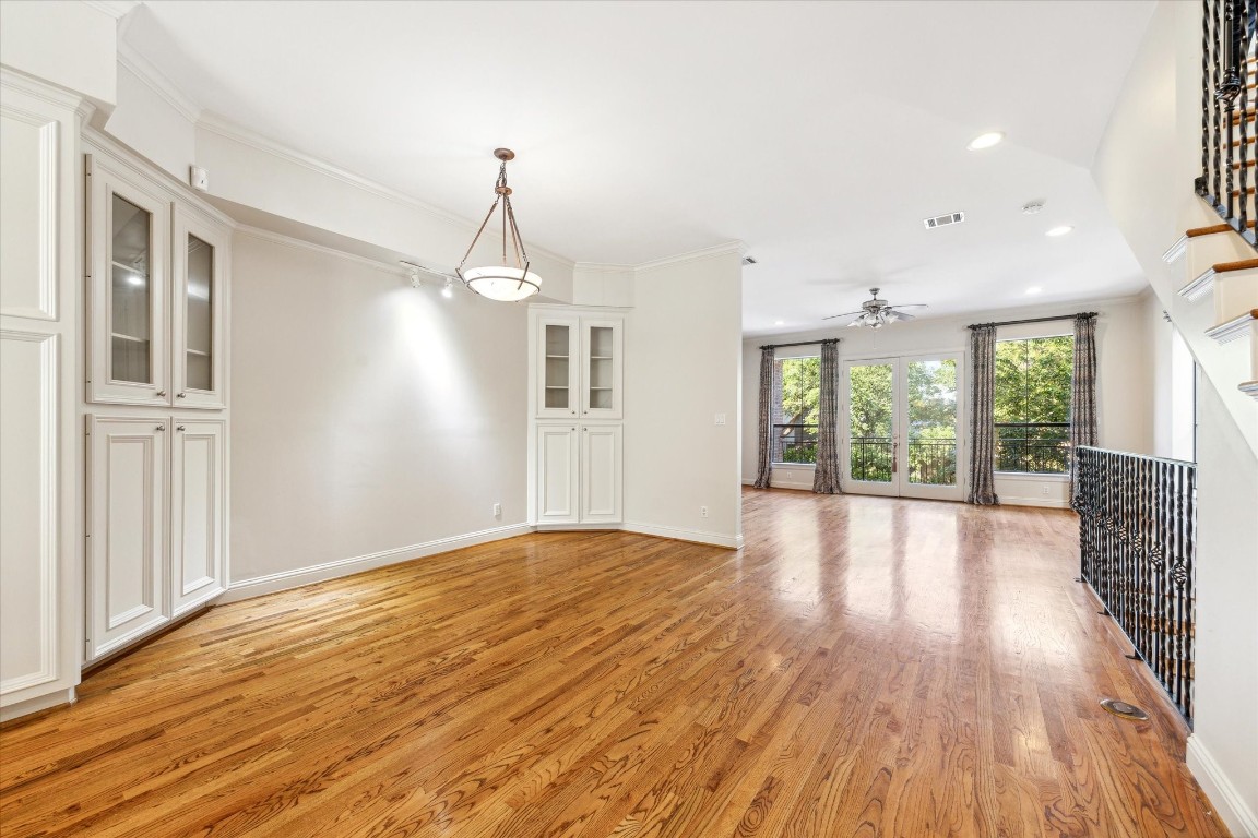 1231 West Pierce Street Houston, TX 77019 - Photo 15 of 33 a view of an empty room with wooden floor and a window