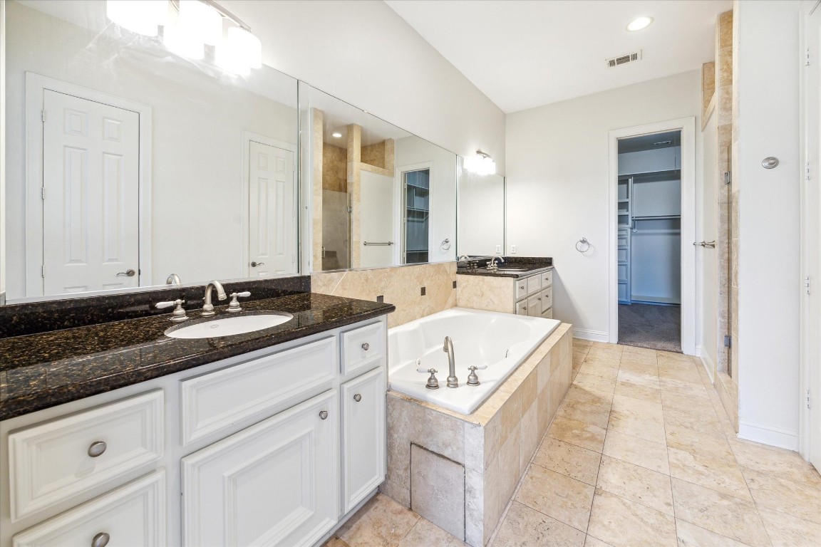 1231 West Pierce Street Houston, TX 77019 - Photo 26 of 33 a spacious bathroom with a granite countertop sink and mirror
