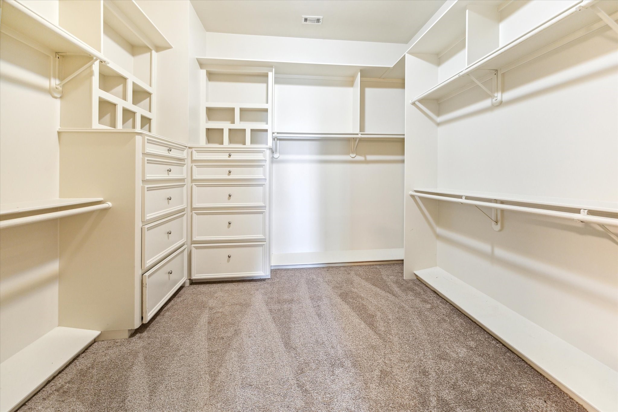 1231 West Pierce Street Houston, TX 77019 - Photo 29 of 33 You’ll never want for wardrobe space thanks to the primary suite’s massive custom closet featuring double hanging rods, rows of shelves and dresser drawers.