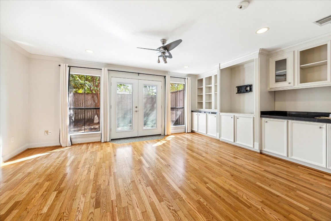 1231 West Pierce Street Houston, TX 77019 - Photo 5 of 33 a view of an empty room with wooden floor and a window