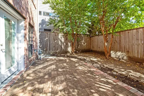 a view of a house with a backyard and a tree