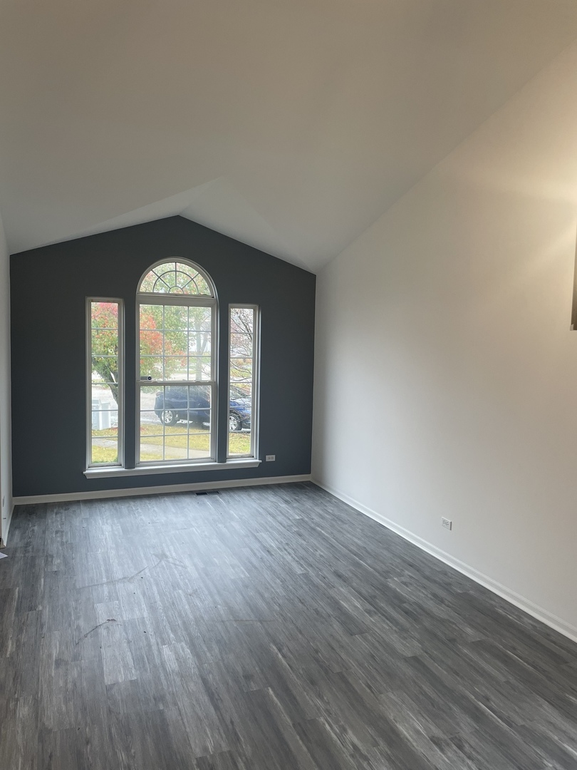 Undisclosed Address Round Lake, IL 60073 - Photo 2 of 15 an empty room with wooden floor and windows