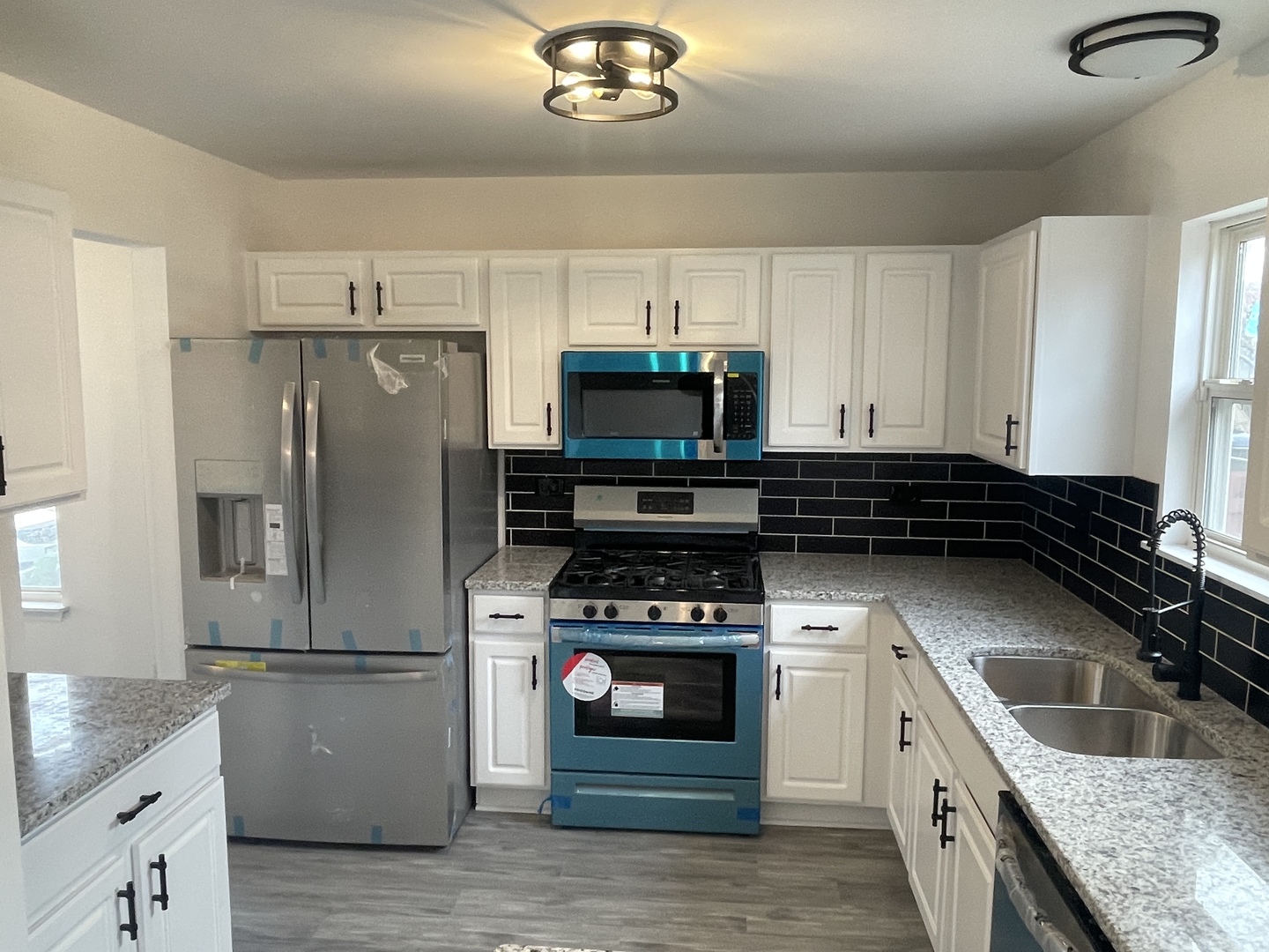 Undisclosed Address Round Lake, IL 60073 - Photo 5 of 15 a kitchen with granite countertop a refrigerator stove and sink