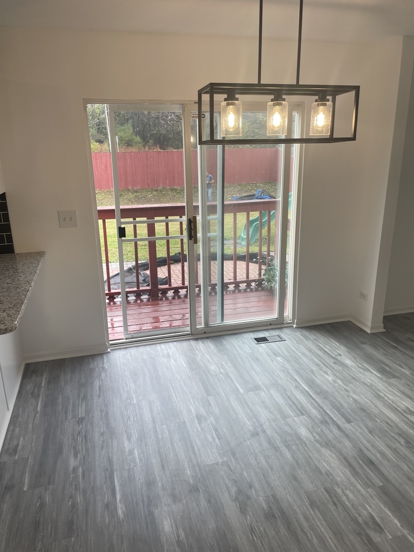 Undisclosed Address Round Lake, IL 60073 - Photo 8 of 15 an empty room with wooden floor and floor to ceiling window