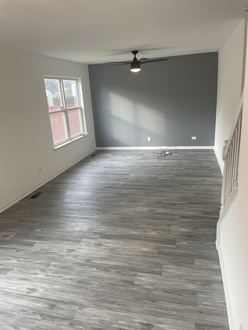 Undisclosed Address Round Lake, IL 60073 - Photo 9 of 15 wooden floor in an empty room with a window