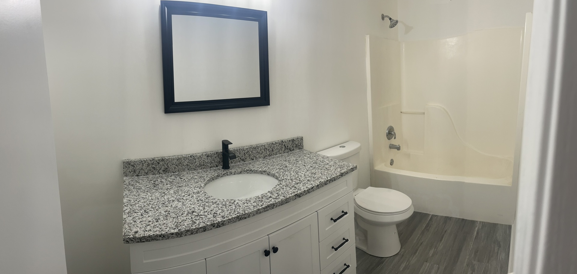 Undisclosed Address Round Lake, IL 60073 - Photo 10 of 15 a bathroom with a granite countertop sink a toilet and bathtub