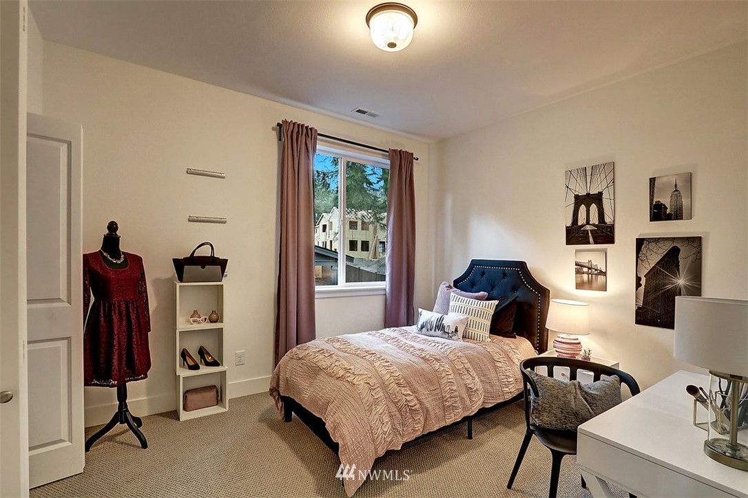 5 232nd Place Southeast Bothell, WA 98021 - Photo 18 of 21 a bedroom with a bed and a flat tv screen on the dresser