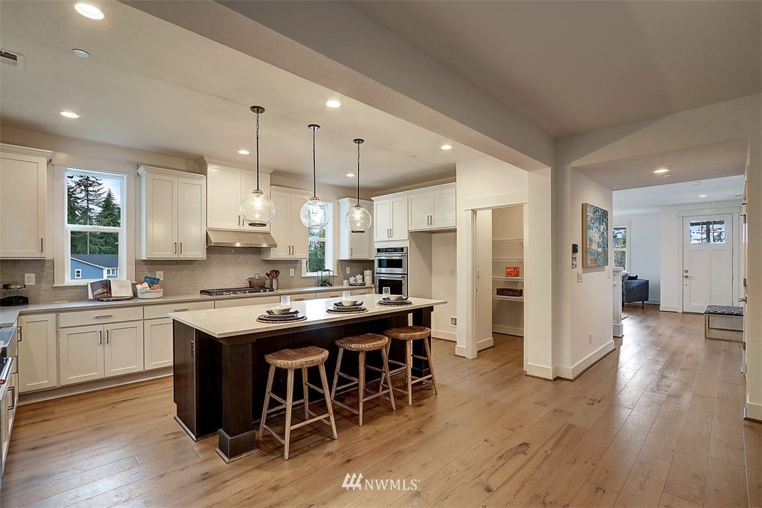5 232nd Place Southeast Bothell, WA 98021 - Photo 5 of 21 a kitchen with stainless steel appliances granite countertop a table and chairs in it