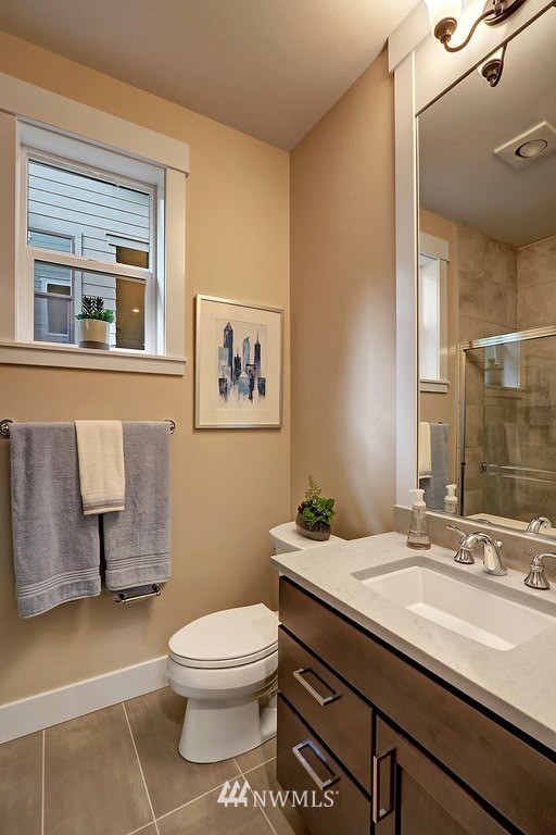 5 232nd Place Southeast Bothell, WA 98021 - Photo 9 of 21 a bathroom with a granite countertop toilet sink and mirror