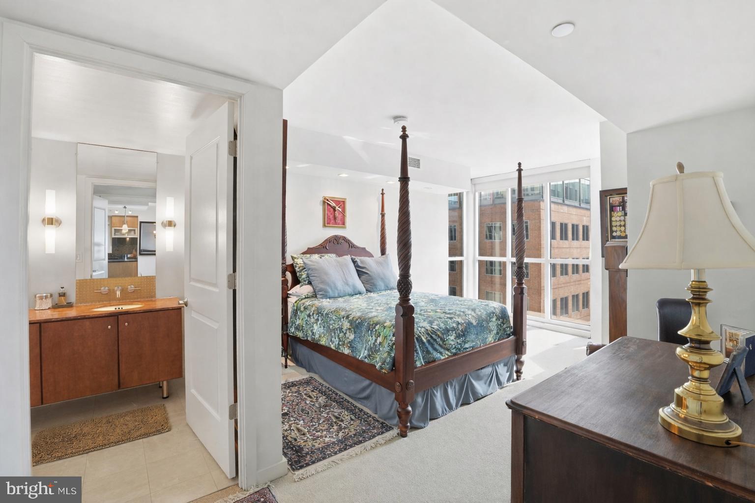 1025 First Street Southeast, Unit 906 Washington, DC 20003 - Photo 10 of 30 a en suite bathroom with a granite countertop sink and mirror