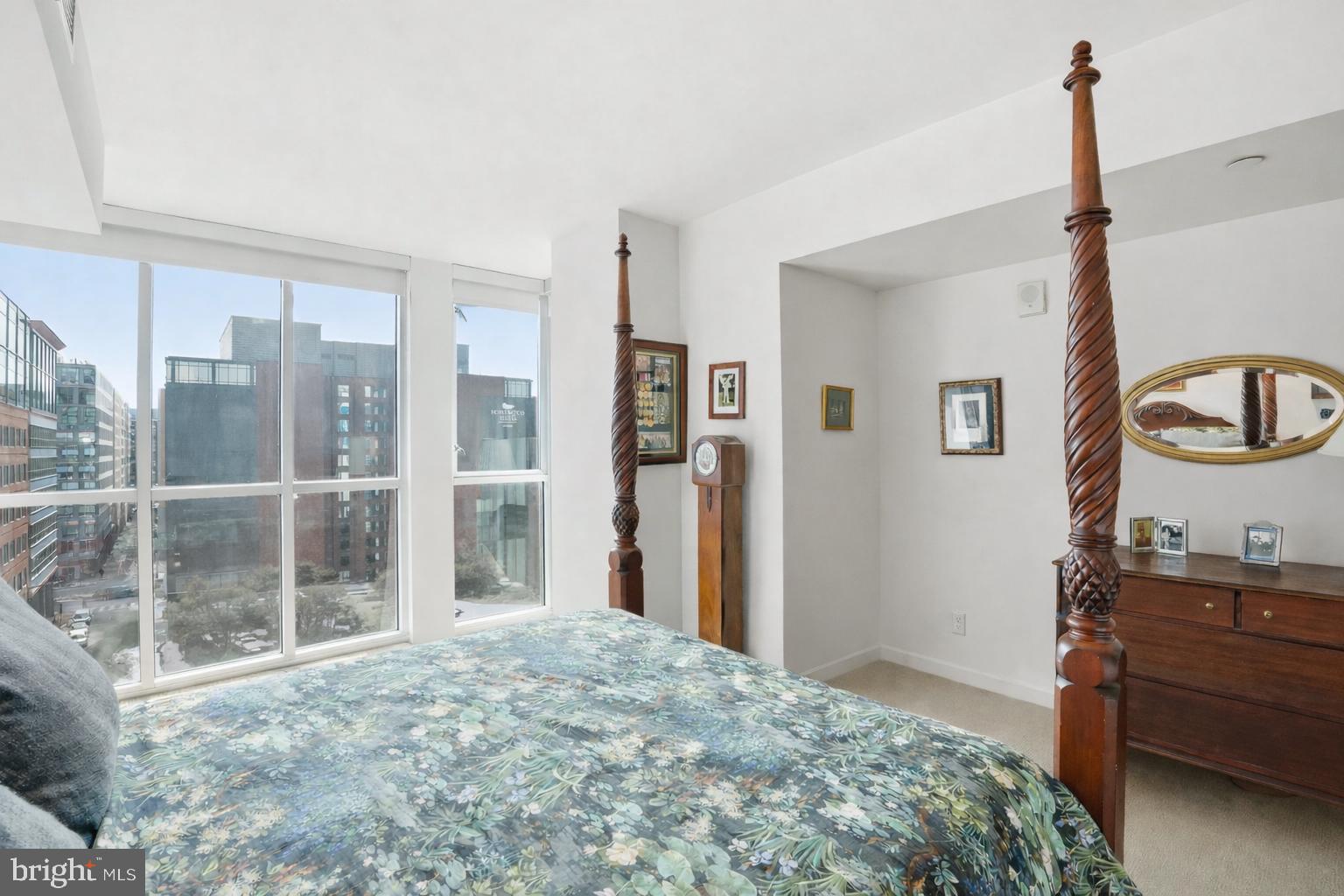 1025 First Street Southeast, Unit 906 Washington, DC 20003 - Photo 11 of 30 a bedroom with a bed window and cabinet