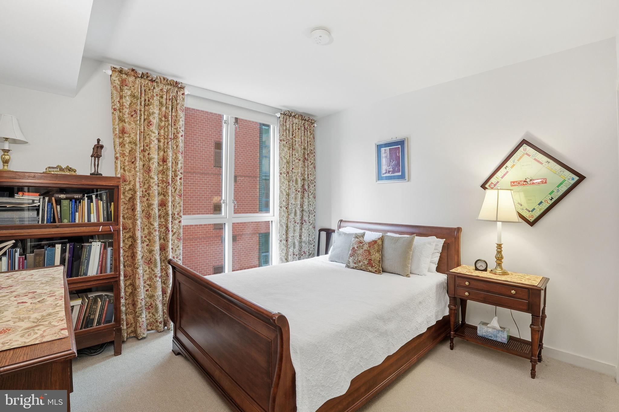 1025 First Street Southeast, Unit 906 Washington, DC 20003 - Photo 13 of 30 a bedroom with a bed and a book shelf