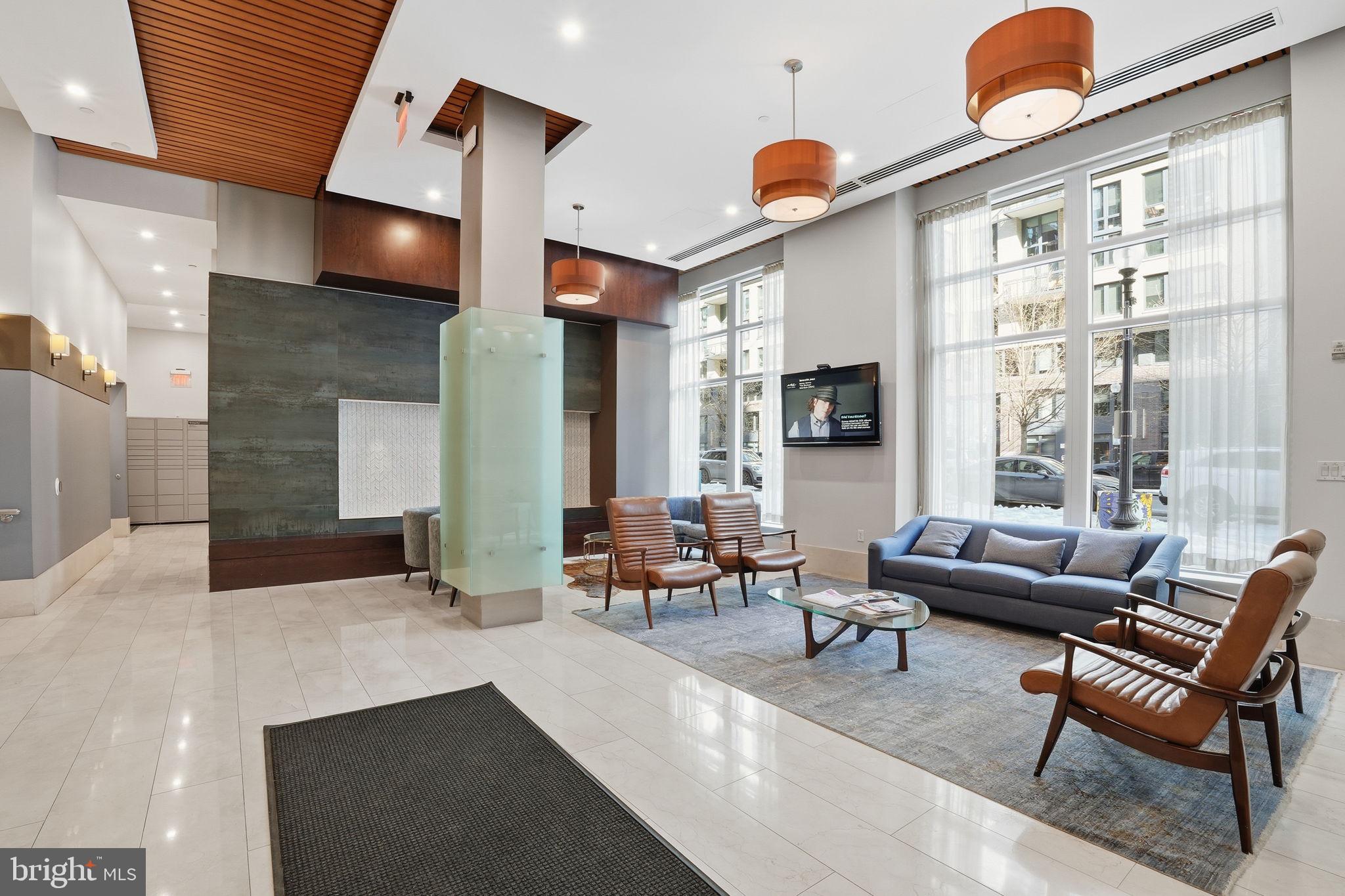 1025 First Street Southeast, Unit 906 Washington, DC 20003 - Photo 22 of 30 a living room with fireplace furniture and a large window