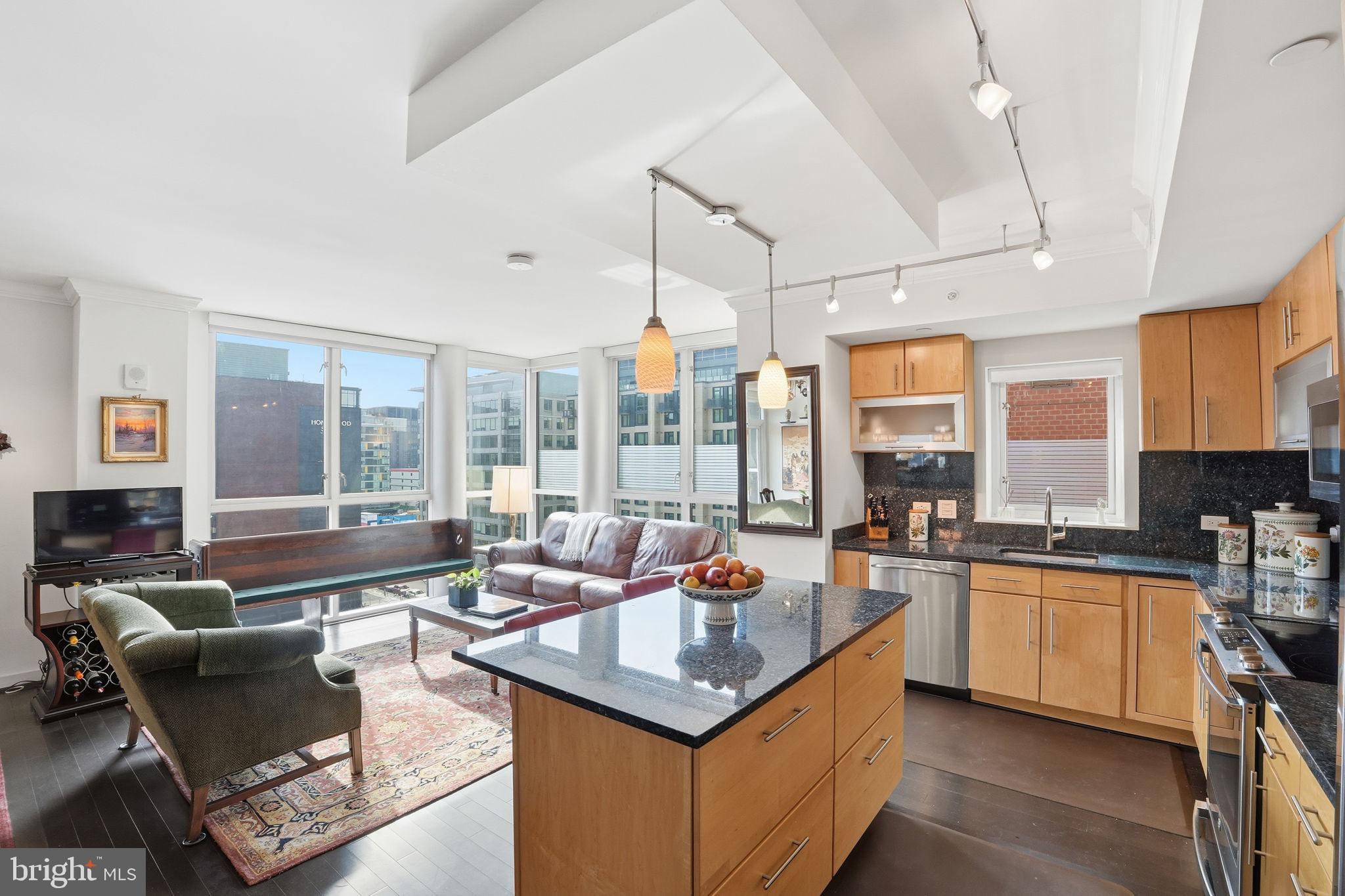 1025 First Street Southeast, Unit 906 Washington, DC 20003 - Photo 2 of 30 a open kitchen with stainless steel appliances granite countertop a sink and cabinets