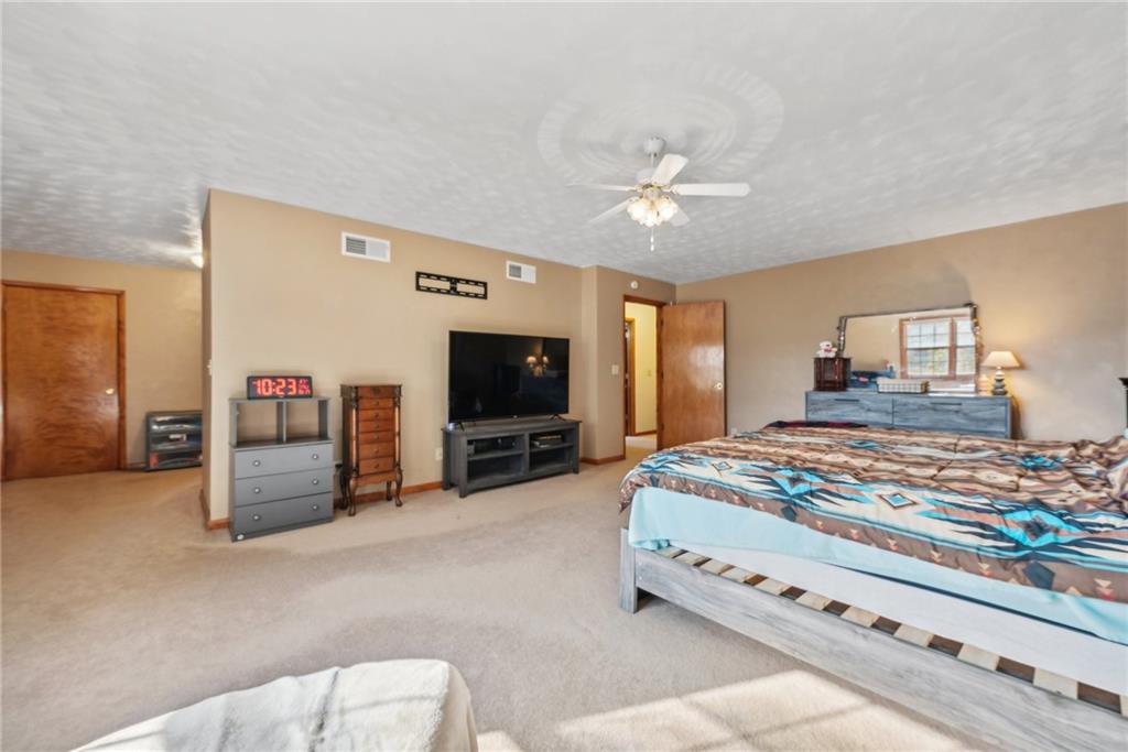 822 Old State Road Apollo, PA 15613 - Photo 15 of 22 a spacious bedroom with a bed and a flat screen tv