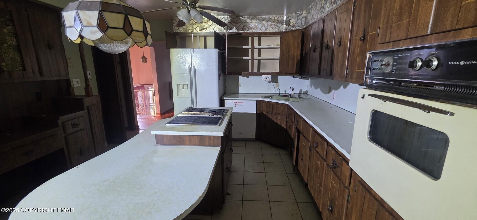 1829 South Webster Avenue Scranton, PA 18505 - Photo 10 of 40 a kitchen with stainless steel appliances granite countertop a refrigerator a stove and a sink with wooden cabinets