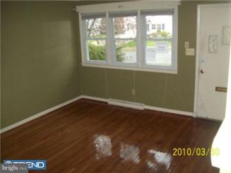 1322 Greenleaf Road Wilmington, DE 19805 - Photo 5 of 7 an empty room with wooden floor and windows