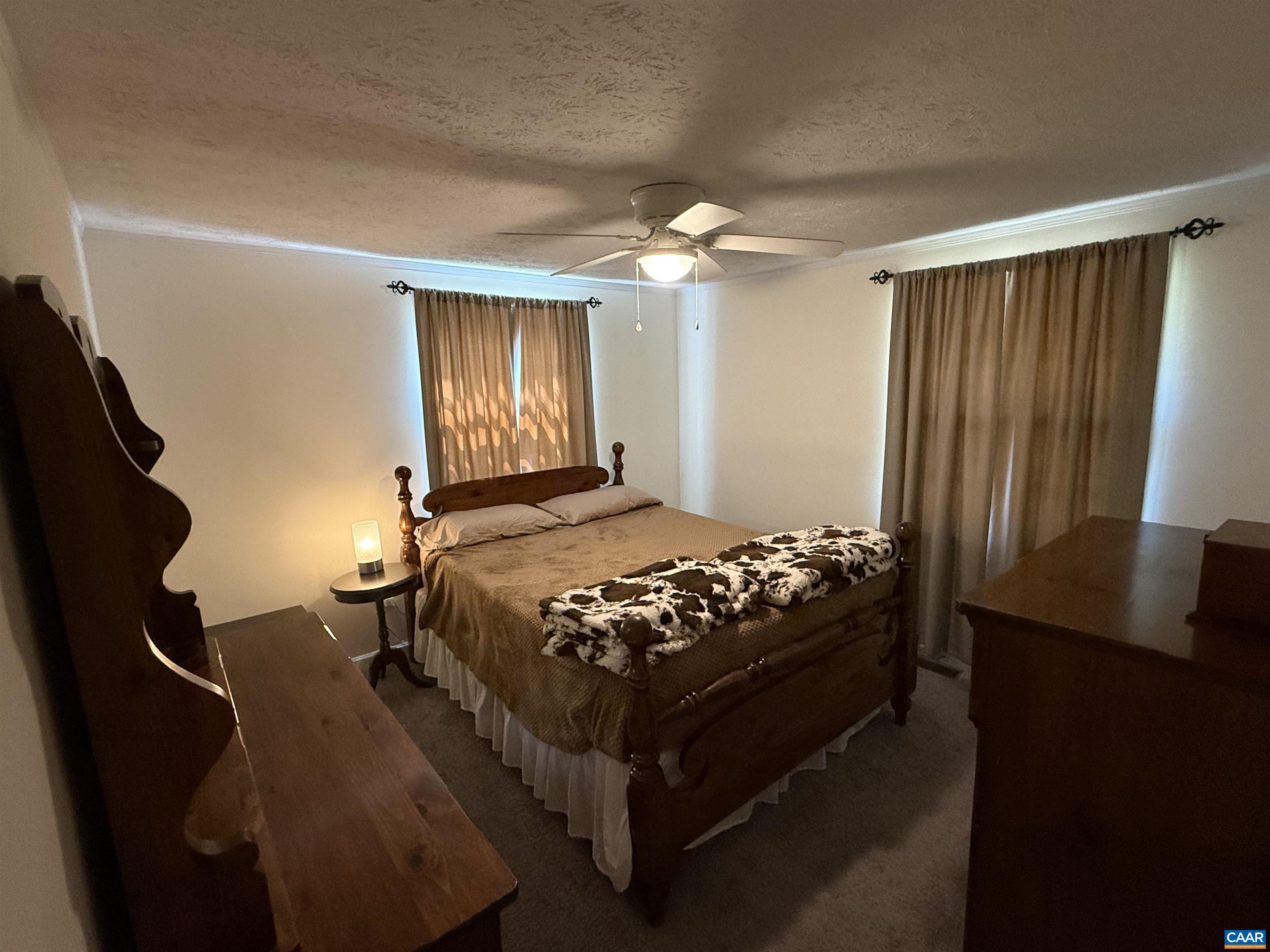 2002 Oliver Creek Road Troy, VA 22974 - Photo 18 of 38 a bedroom with a bed and a chandelier