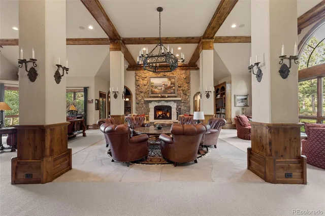 a living room with furniture fireplace and chandelier