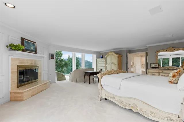 a spacious bedroom with a bed and a fireplace