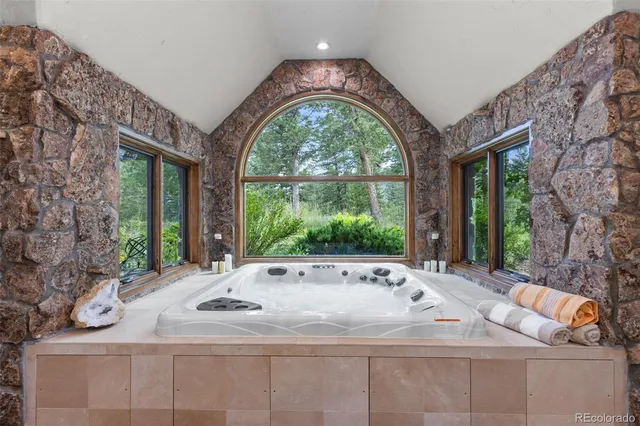 a bath tub sitting in a bathroom next to a window