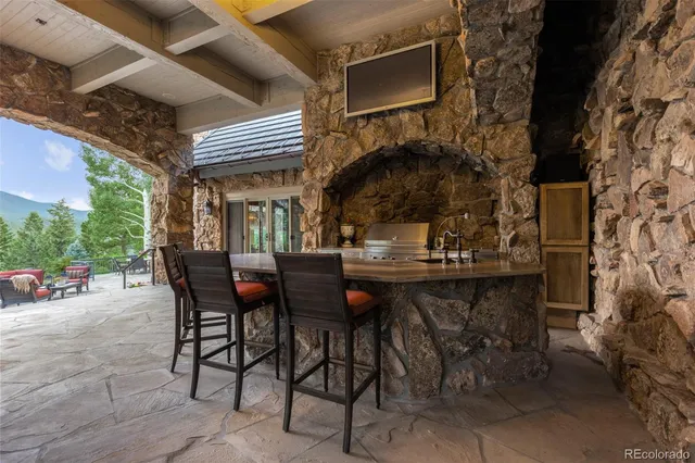 a view of a patio with table and chairs and potted plants