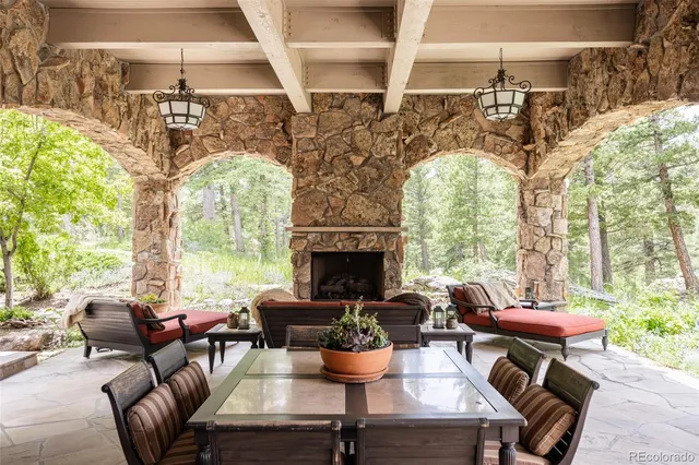 a living room with patio furniture and a fireplace