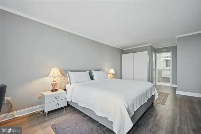 a large bed sitting in a bedroom and table