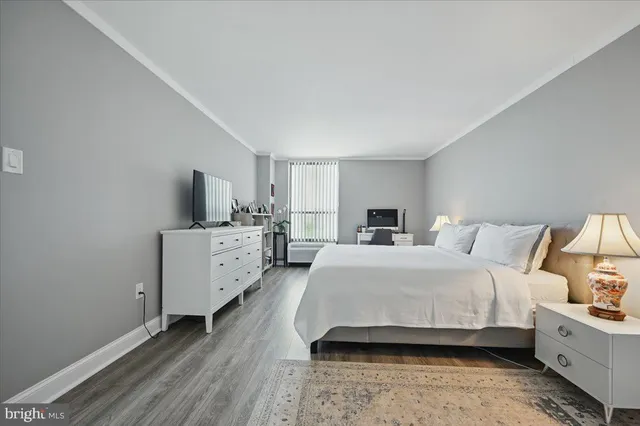 a room with a bed and a view of kitchen