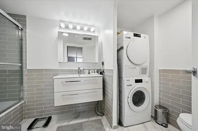 a bathroom with a sink mirror vanity and toilet