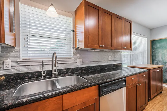 a kitchen with granite countertop a sink and a granite top