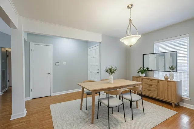 a view of a dining room with furniture window and wooden floor