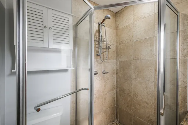 a bathroom with a glass shower door