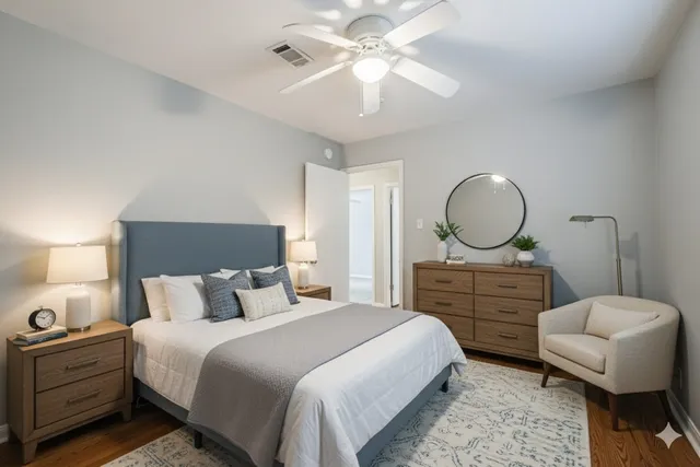 a bedroom with a large bed and a chandelier