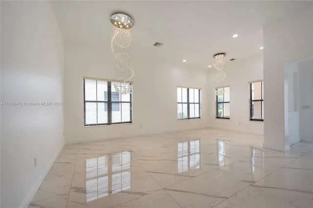 a kitchen with granite countertop white cabinets and stainless steel appliances