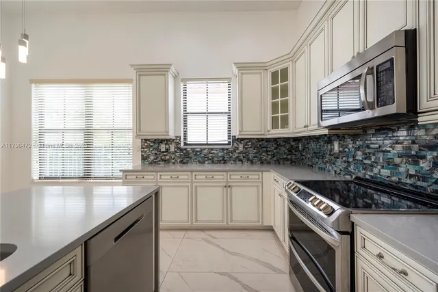 a view of kitchen with refrigerator and window