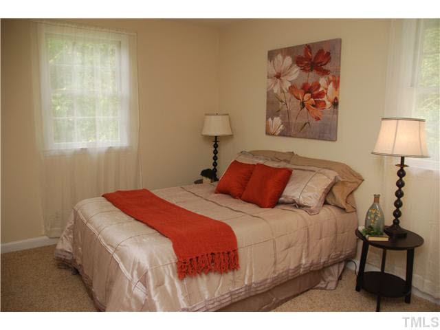 1217 North King Charles Road Raleigh, NC 27610 - Photo 12 of 17 a bedroom with a bed and a painting on the wall