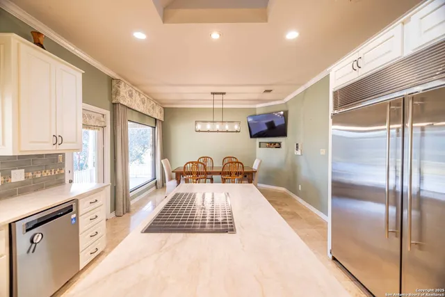 a kitchen with stainless steel appliances granite countertop a refrigerator and a stove top oven