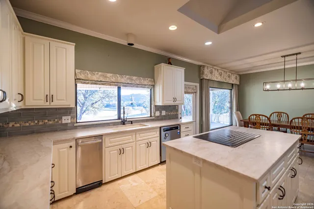 a kitchen with granite countertop cabinets a sink and appliances