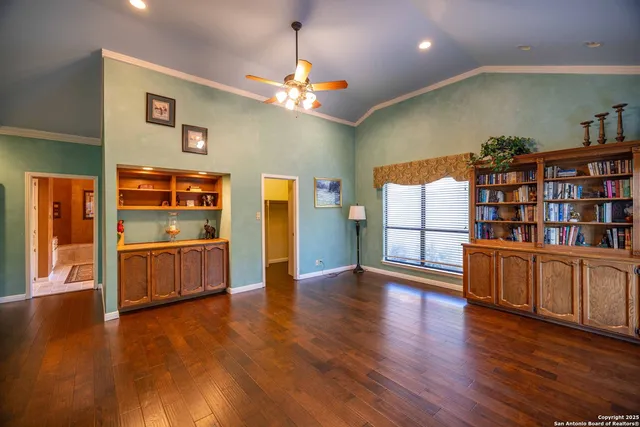 a view of a kitchen with furniture and wooden floor