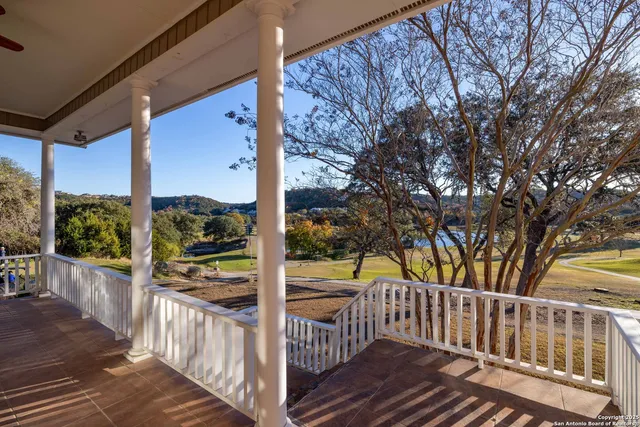 a view of a porch with wooden floor and fence